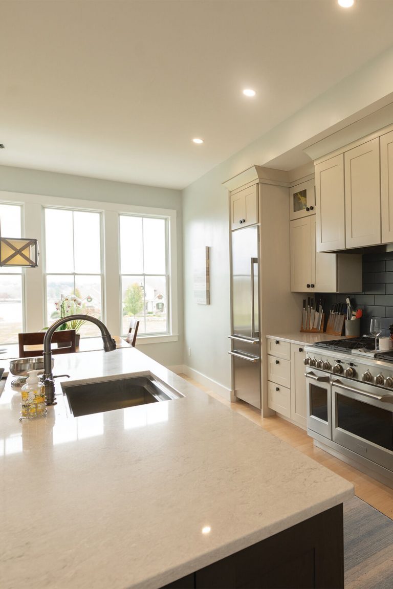 Open-concept kitchen and dining layout by Woodstone Homes in Dover NH